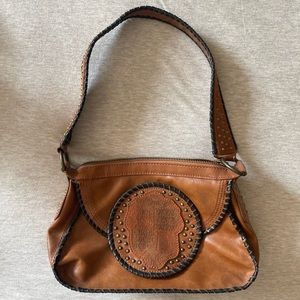 BCBGirls leather Carmel brown handbag with black stitch trim and bronze studs